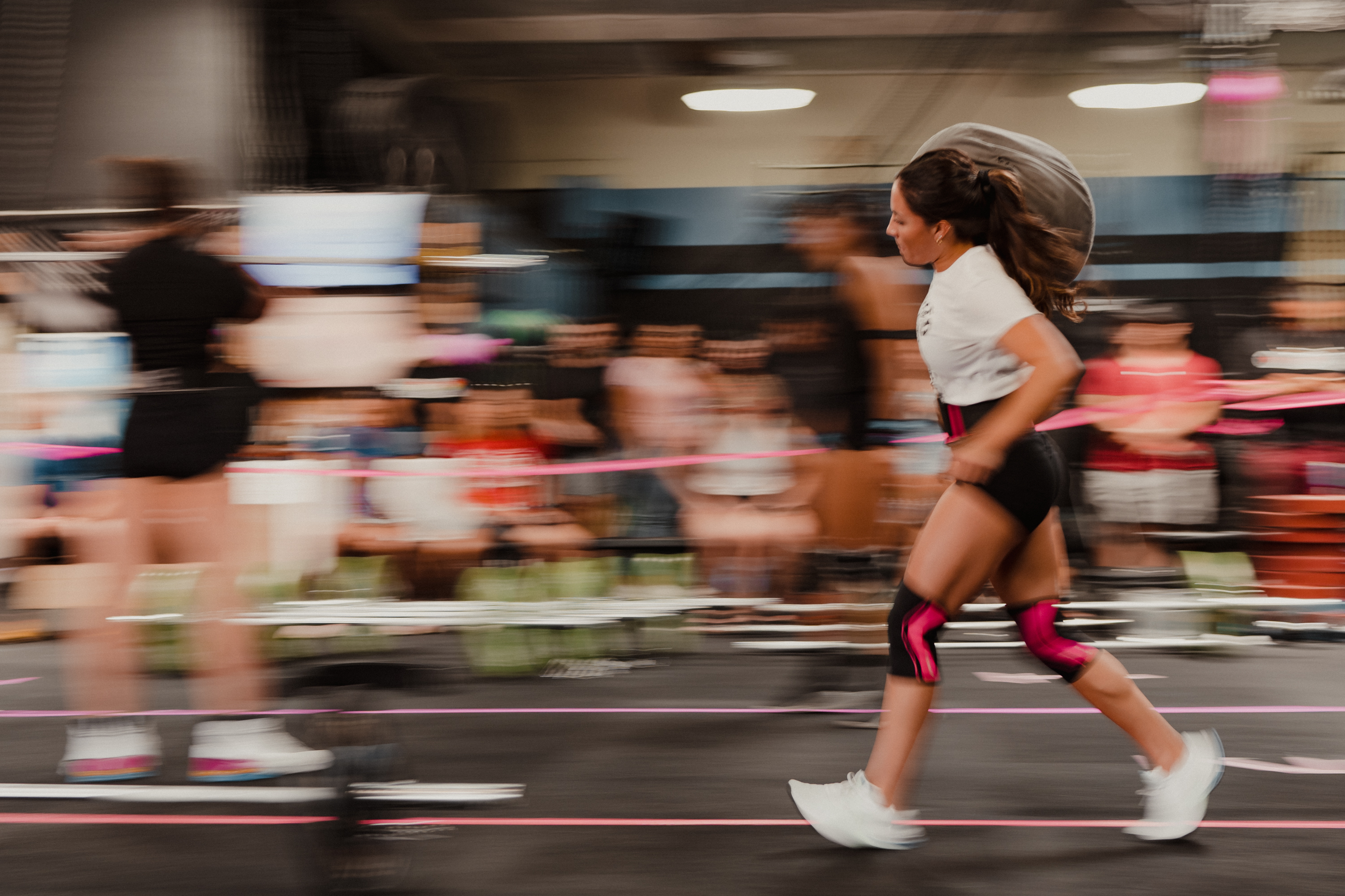 Motion blur of woman running at a Barbells for Boobs event